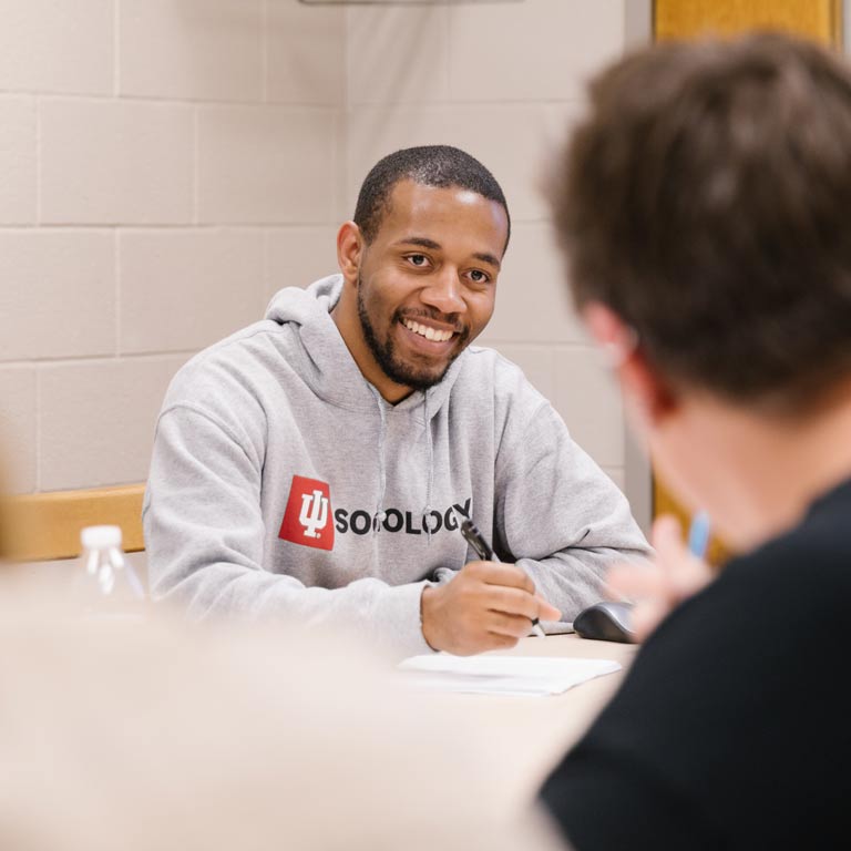 Student in a Sociology sweatshirt smiling