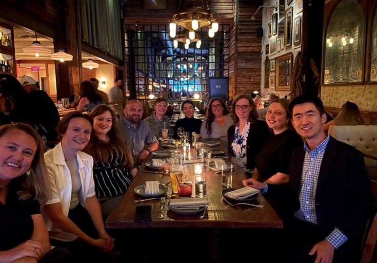 A group of people pose together at a long table in a restaurant. Pictured from left to right: Sarah Diefendorf [IU Visiting Scholar], RA Lauren Beard [UChicago], Hillary Steinberg [Census], Seth Abrutyn [UBC], Robert Gallagher [IU], Jienian Zhang [IU], Katie Beardall [IU], Anna Mueller, Olivia DeCrane [IU], and Yingjian Liang [IU].