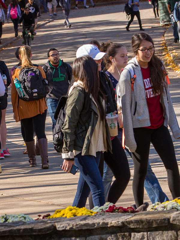 A street outside Ballantine Hall, crowded with students walking to class.