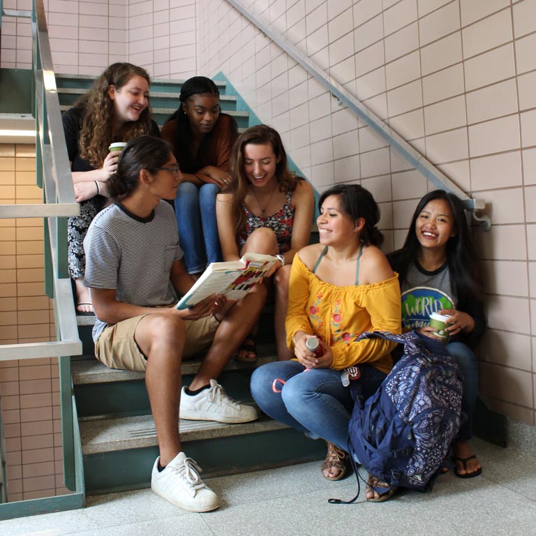 A group of students sitting in a staircase